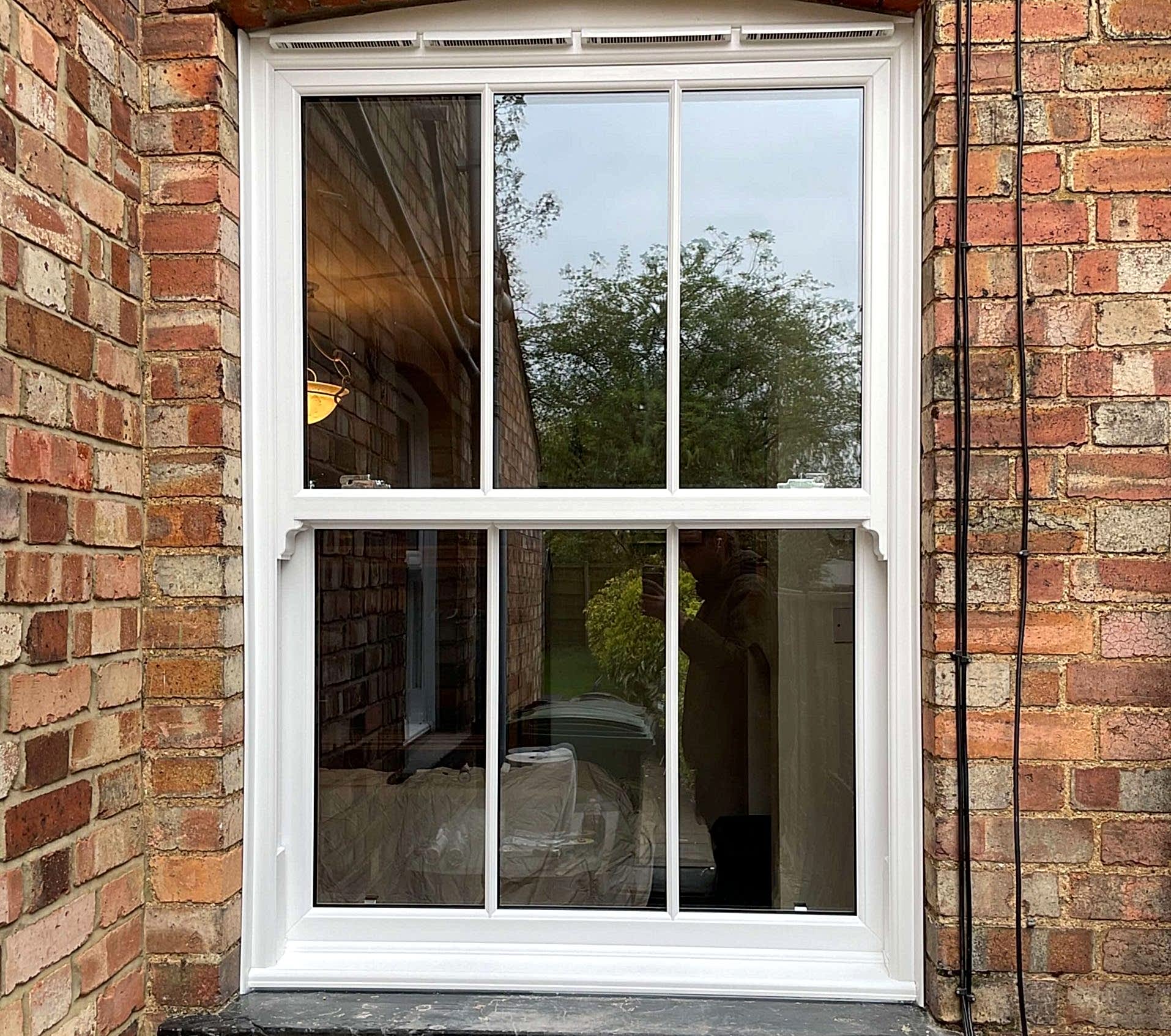 Modern living room with large windows, stylish furniture & light