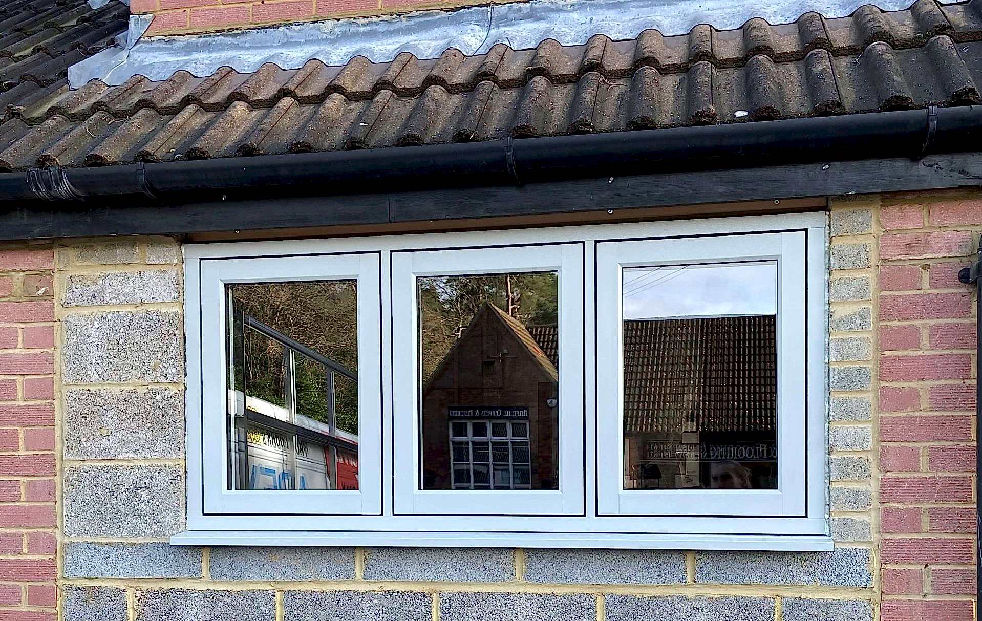 Triple-panel window reflecting opposite building | D2R Windows