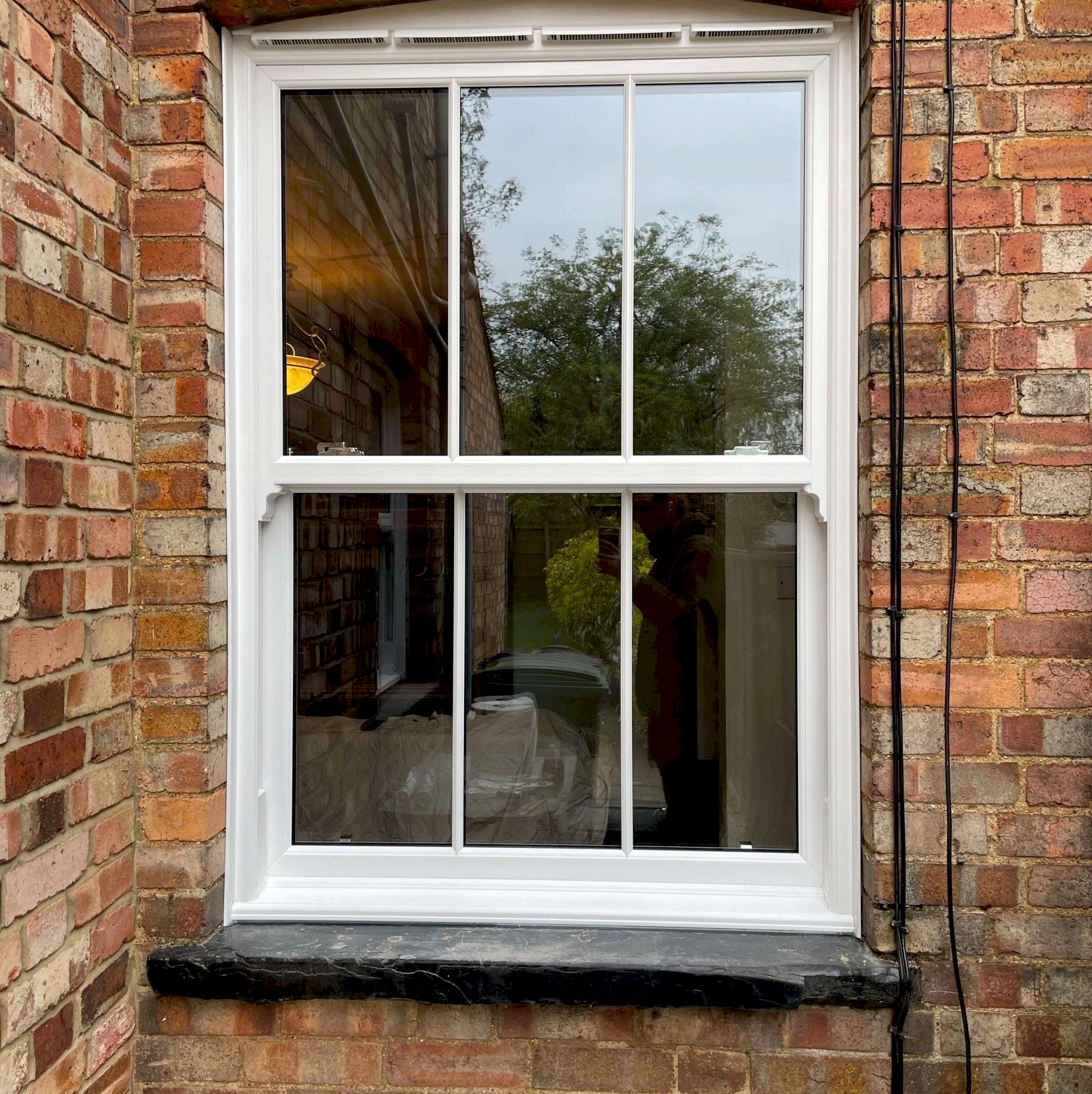 Modern living room with large windows, stylish furniture & light