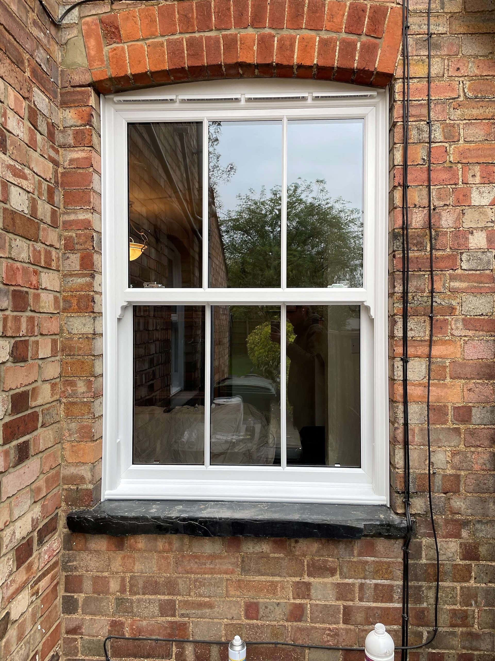 Modern living room with large windows, stylish furniture & light
